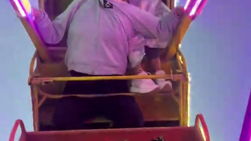 She is holding onto her on the roller coaster.